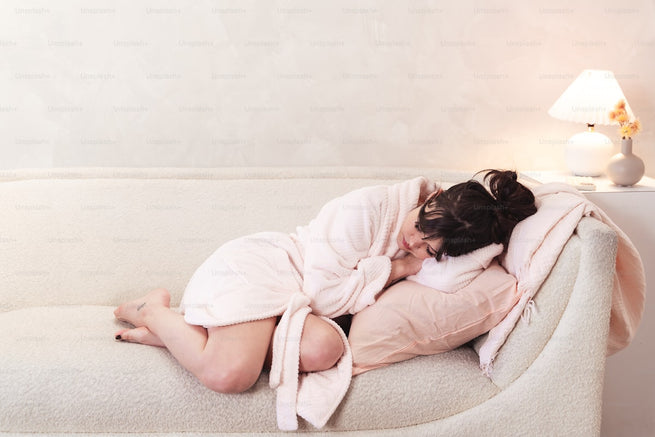 Woman resting on couch - recognizing UTI symptoms